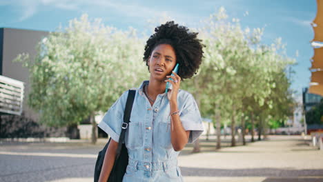 young woman talking on smartphone outdoors