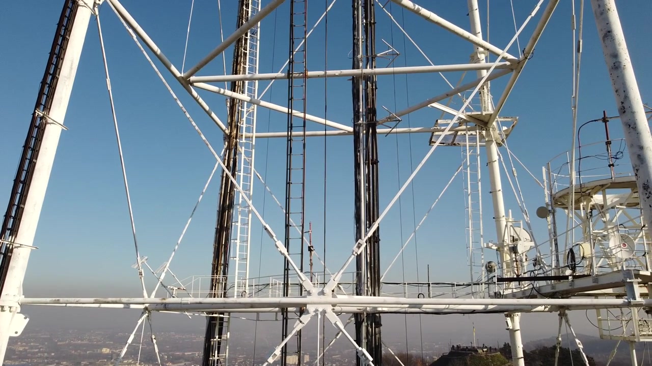 Aerial view of a drone flying near TV tower.