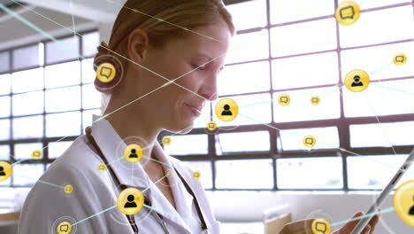 Animation-of-network-of-connections-with-icons-over-caucasian-female-doctor-using-tablet