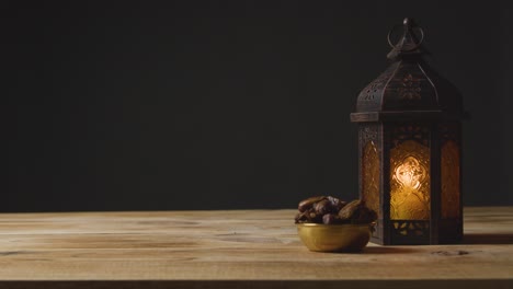 stationary shot of hand taking a drink of water on a table for ramadan