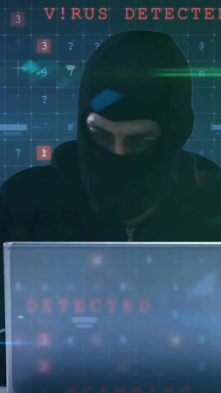 Video animato mostra un hacker con il laptop tra colorate reti di dati.