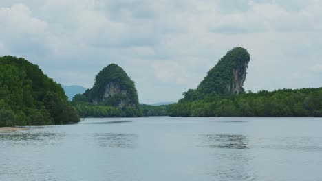 4K-Cinematic-landscape-footage-of-the-urban-forest-and-rock-formation-of-Pak-Nam-in-the-town-of-Krabi,-South-Thailand-by-the-river-marina-on-a-sunny-day