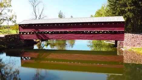 aerial over a pretty historic red covered bridge near gettysburg pennsylvania 1