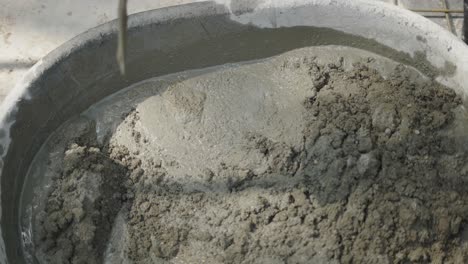 close-up of manual concrete mixing