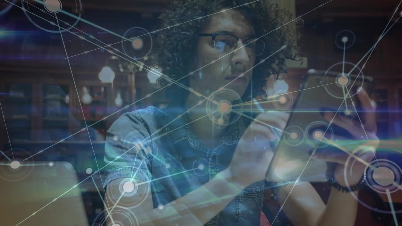 Animation of network of connections with icons over businessman using tablet