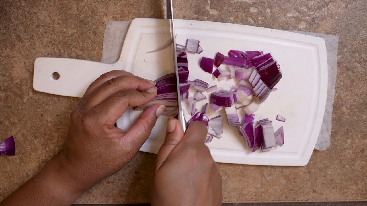Chopping red onion for a homemade recipe - overhead view LAMB PATTY SERIES