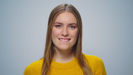 Portrait-of-happy-woman-enjoying-dollar-banknotes-at-camera-in-studio.