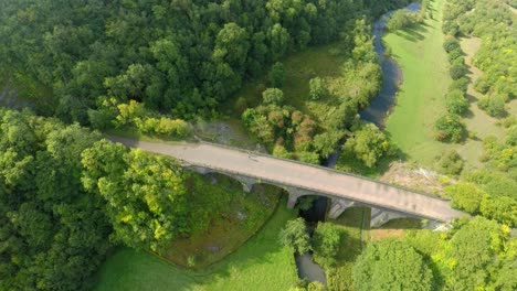 Aerial-view,-footage-of-Headstone-Viaduct-in-Bakewell,-Derbyshire,-the-Peak-District-National-Park,-on-a-beautiful-cloud-filled-Summers-day,-commonly-used-by-cyclists,-hikers,-popular-with-tourists