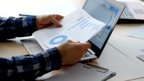 business office worker typing laptop papers