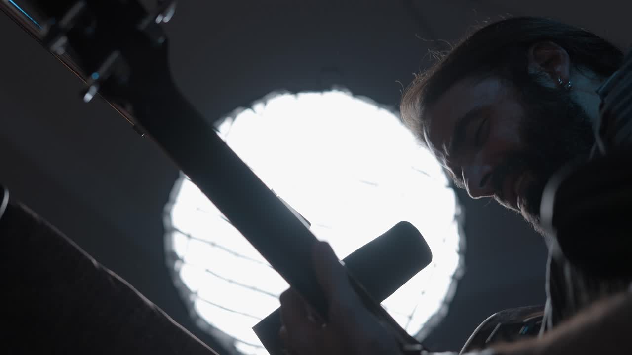 Man Playing Electric Guitar in Recording Studio