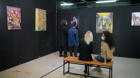 people viewing art in an exhibition hall