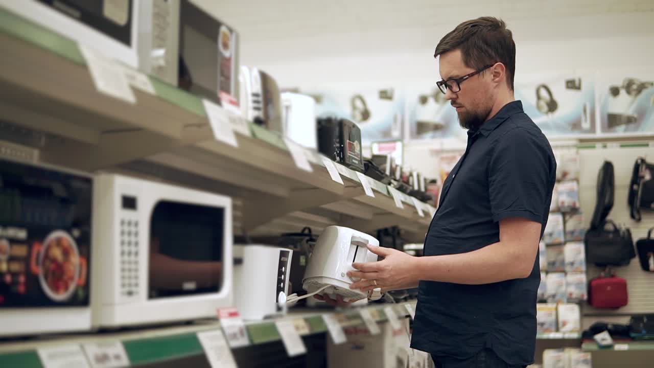 Man Shopping for Appliances in a Retail Store