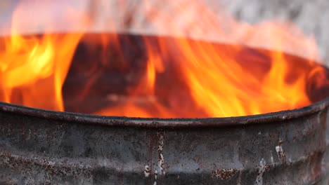 burning rusty barrel