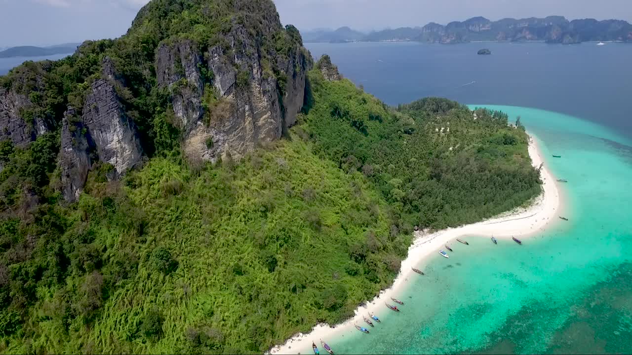 Fantastica ripresa con drone di un'isola tropicale verde e montuosa.