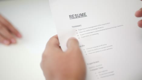 close up hand to greet a hr staff before a job interview to apply for a job. smart asian woman sending resume.