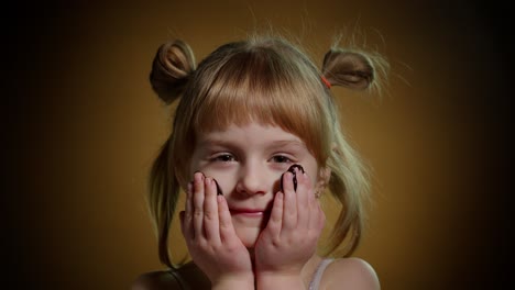 Portrait-of-teen-child-kid-smears-face-with-melted-dark-chocolate-and-starts-eating-chocolate-bar