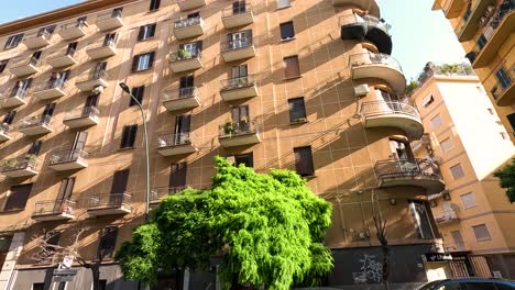 a building with balconies and greenery