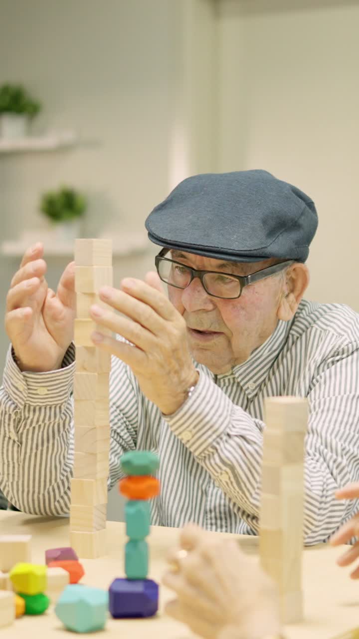 Elderly man playing a game of wood blocks