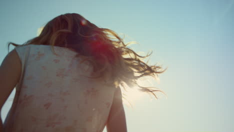 Closeup-happy-woman-in-love-dancing-in-light-outdoors.-Smiling-woman-in-sunshine