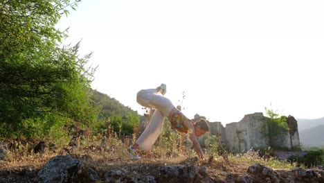 Yoga-the-girl-doing-yoga-with-a-headstand-on-the-grass