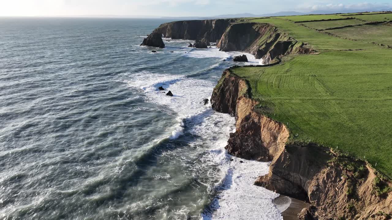 Ireland Epic locations strong sea swell waves crashing on fragile sea cliffs prone to coastal erosion Waterford Coast