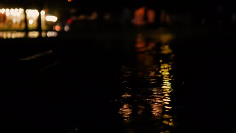 beautiful night city background with rain dripping on a puddle. night rain.