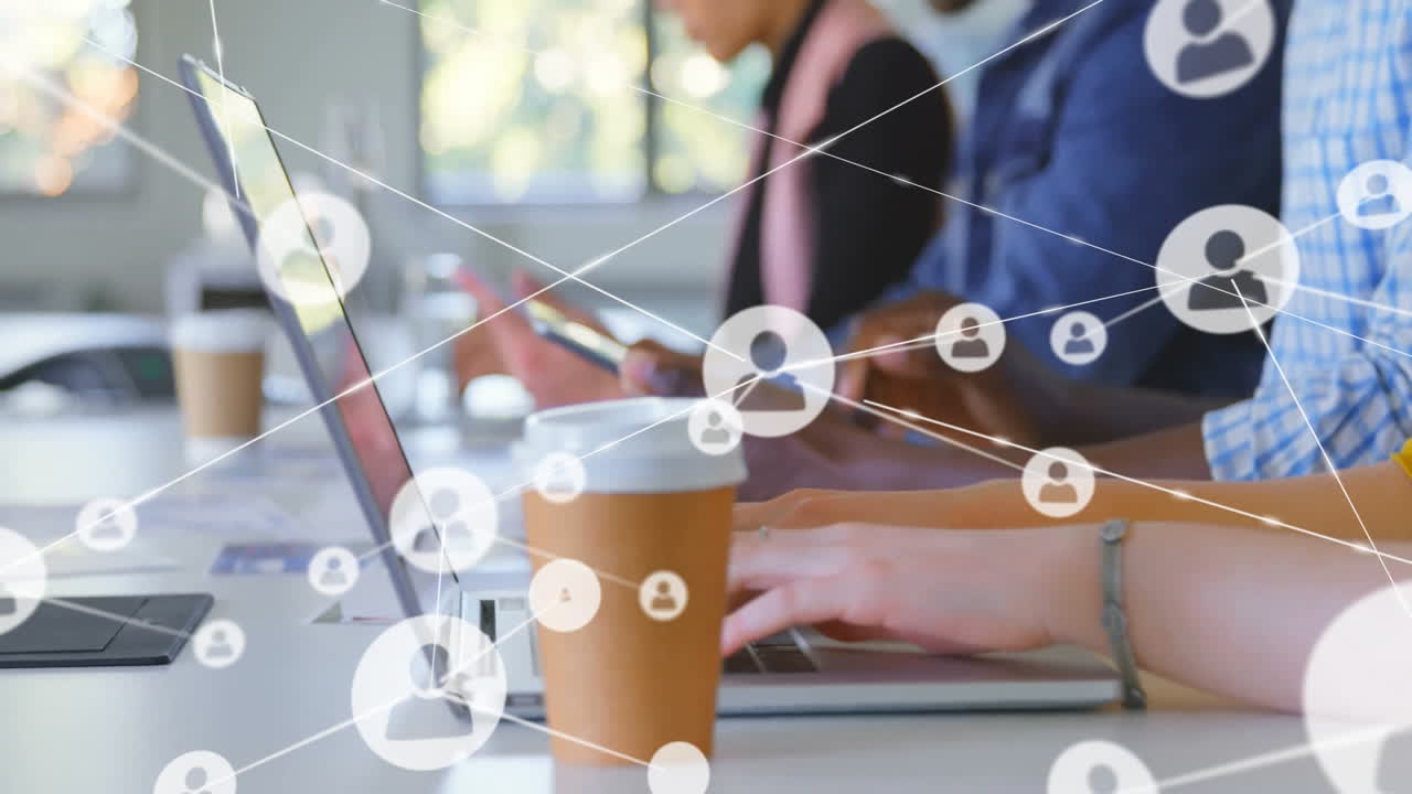 Working on laptops with network connections and animation of user icons overlay