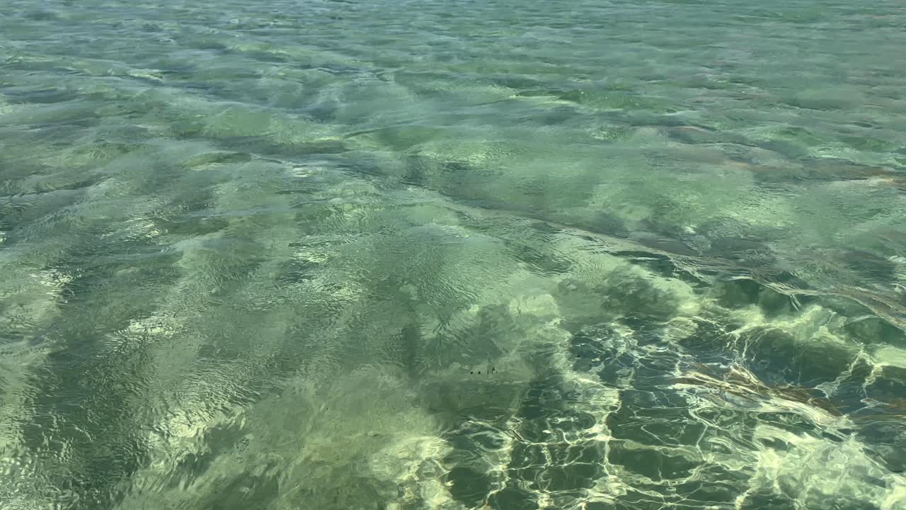 transparent shallow water with sunlight reflections at Balos Lagoon, Crete Island, Greece