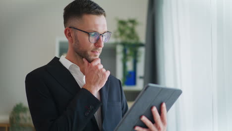 confident businessman working on digital tablet