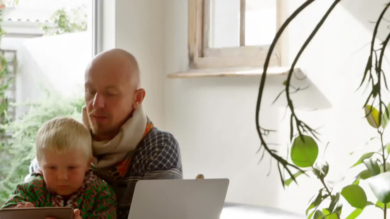 Caucasian man and his son during coronavirus covid19 pandemic with words Stay Home