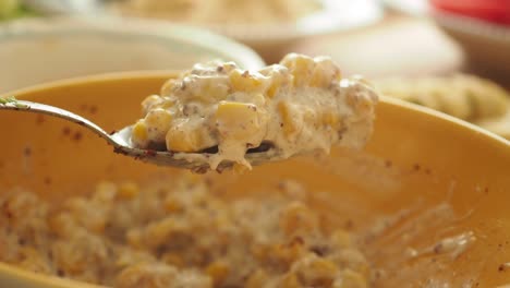 close-up of creamy corn salad on a spoon