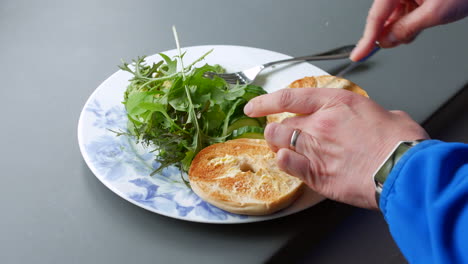 Frau,-Die-Einen-Bagel-Und-Salat-Zum-Frühstück-Buttert