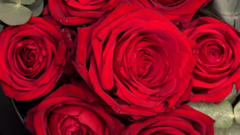 gentle colourful bouquet of red roses on turn table, close-up