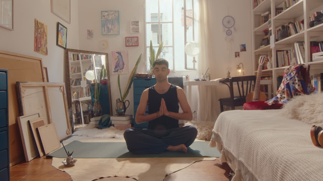 Young Man Practicing Yoga Meditation at Home