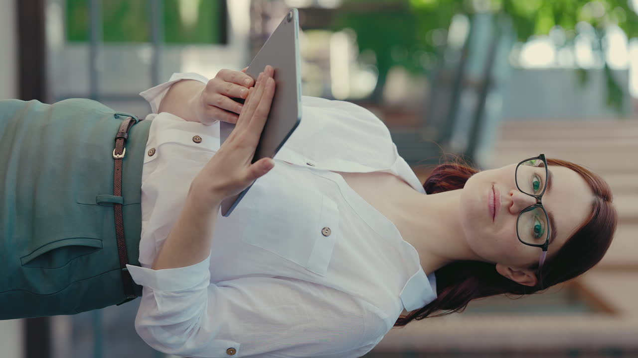 Woman holding tablet outdoors