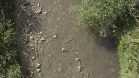 Aerial-drone-shot---slow-fly-over-creek-looking-straight-down-while-creek-runs