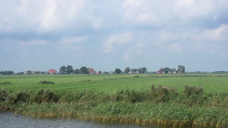 Dairy-farms-below-sea-level,-filmed-from-a-passing-ship