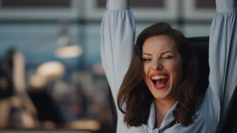 happy lady rejoicing victory office late night closeup. woman enjoying success