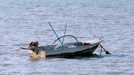 a lone boat gently floats on the water