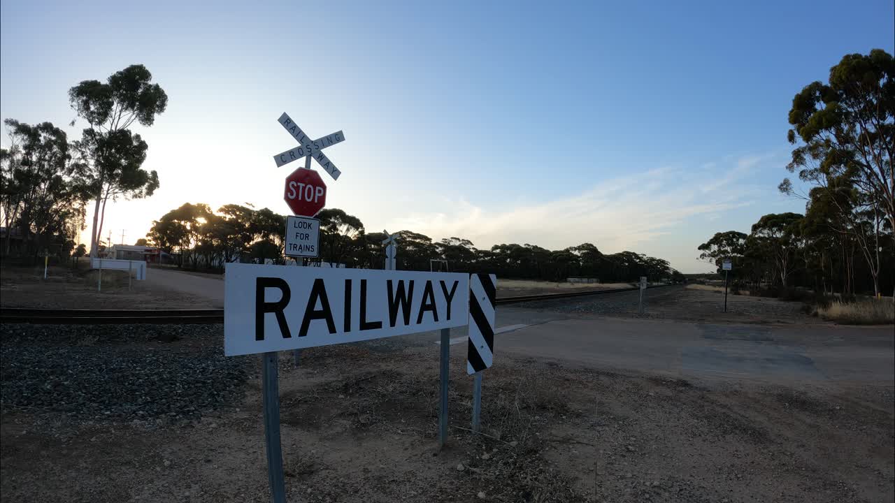 Train Approaching Railway Crossing in Australian Outback