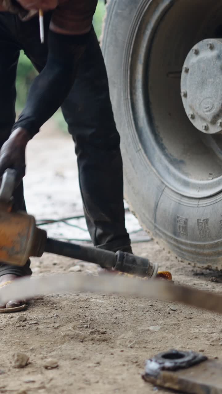 Mechanic repairing a truck tire