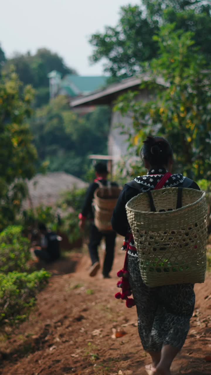 People walking in a rural village with baskets
