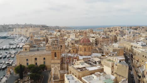 aerial counterclockwise wide shot of senglea basilica in malta