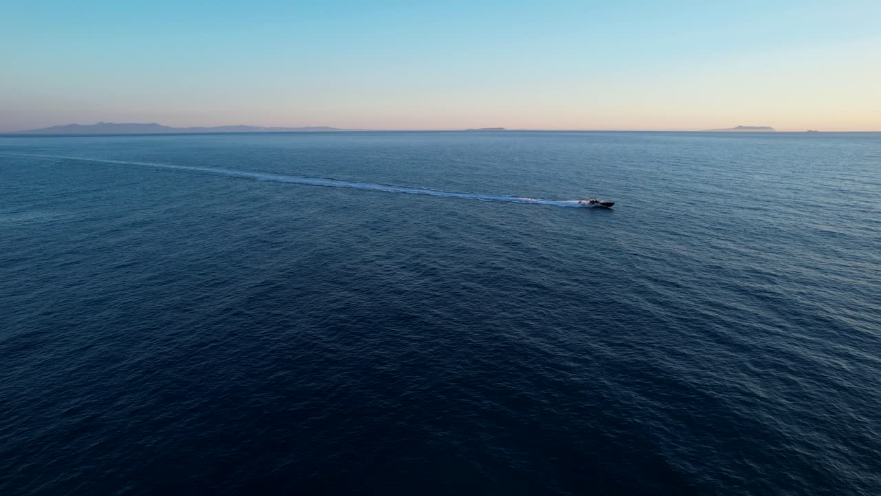 Speedboat Cruising on Deep Blue Sea Near Rocky Bay During Golden Hour Ionian Coast