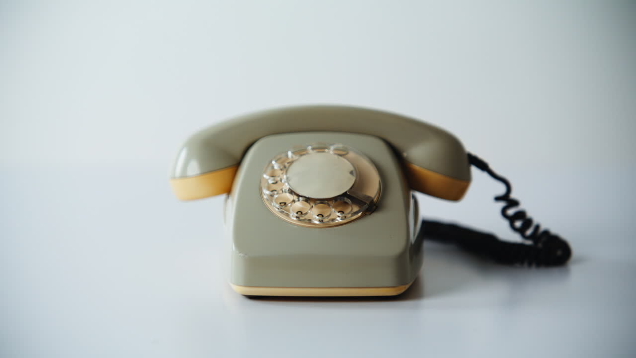 Retro stationary cell phone standing on white background closeup. Vintage rotary