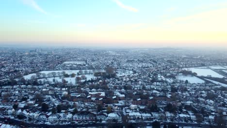 wide angle establishing aerial shot of town covered in snow, england