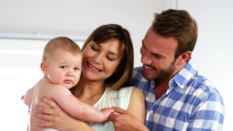 Happy-parents-looking-their-baby-