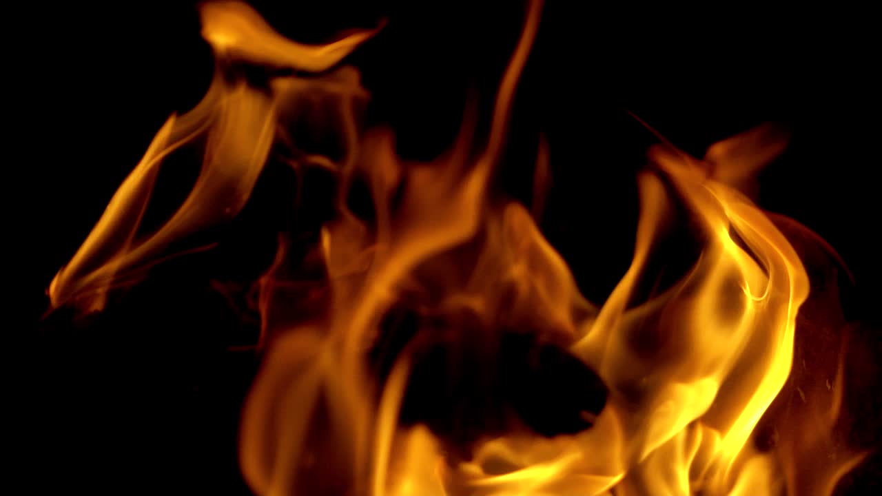 Burning fire. Bright burning wood slow motion. Splashes of flame and live coals.