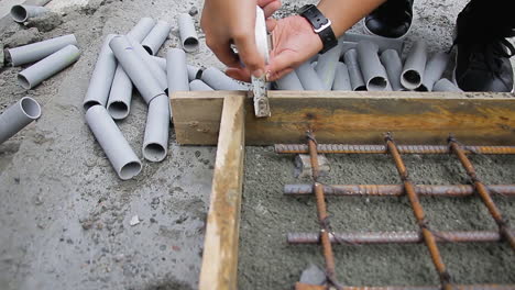 accurate measurement and fitting of materials inside a wooden slab with tools by an indian woman supervisor