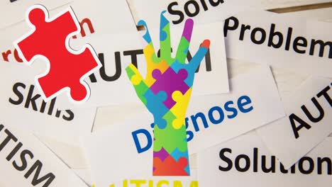 animation of colourful puzzle pieces and autism awareness month text